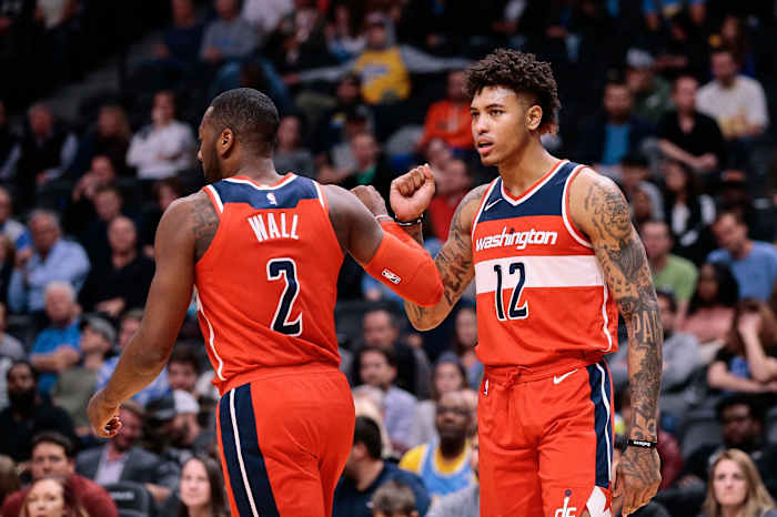 Washington Wizards guard John Wall (2) and forward Kelly Oubre Jr. (12) react after a play in the fourth quarter against the Denver Nuggets at the Pepsi Center.